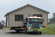 House being transported to its final destination by Genius Homes